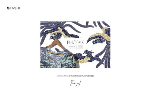 Front view of a paper wallpaper mockup featuring a blue and gold phoenix pattern with botanical accents on a white background.