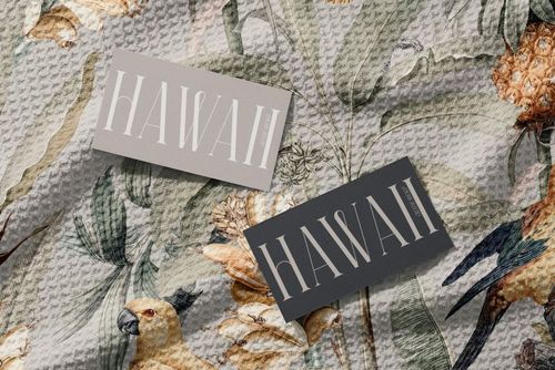 PSD mockup showing a detailed view of a patterned waffle beach towel, decorated with flowers and birds, and two 'HAWAII' cards.