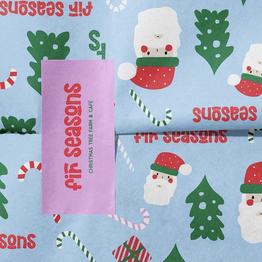 Sticker mockup featuring a festive design with Santa faces, Christmas trees, candy canes, and red text on a light blue background.