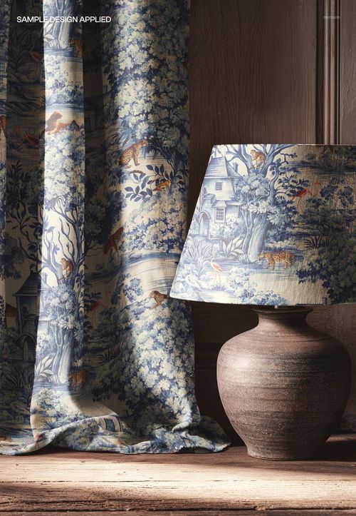 PSD mockup displaying a curtain and lamp with detailed forest and wildlife motifs, set against a wooden wall.