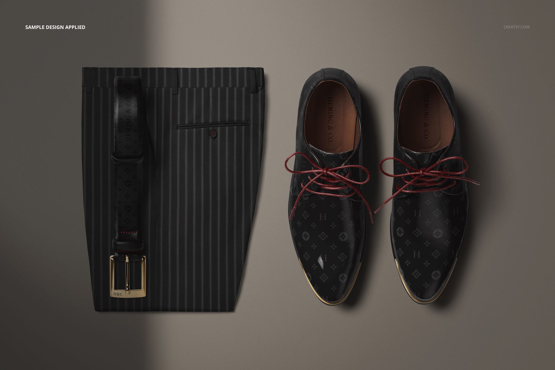 Mockup displaying men’s dress trousers, a textured black belt, and polished Oxford shoes arranged on a neutral background.