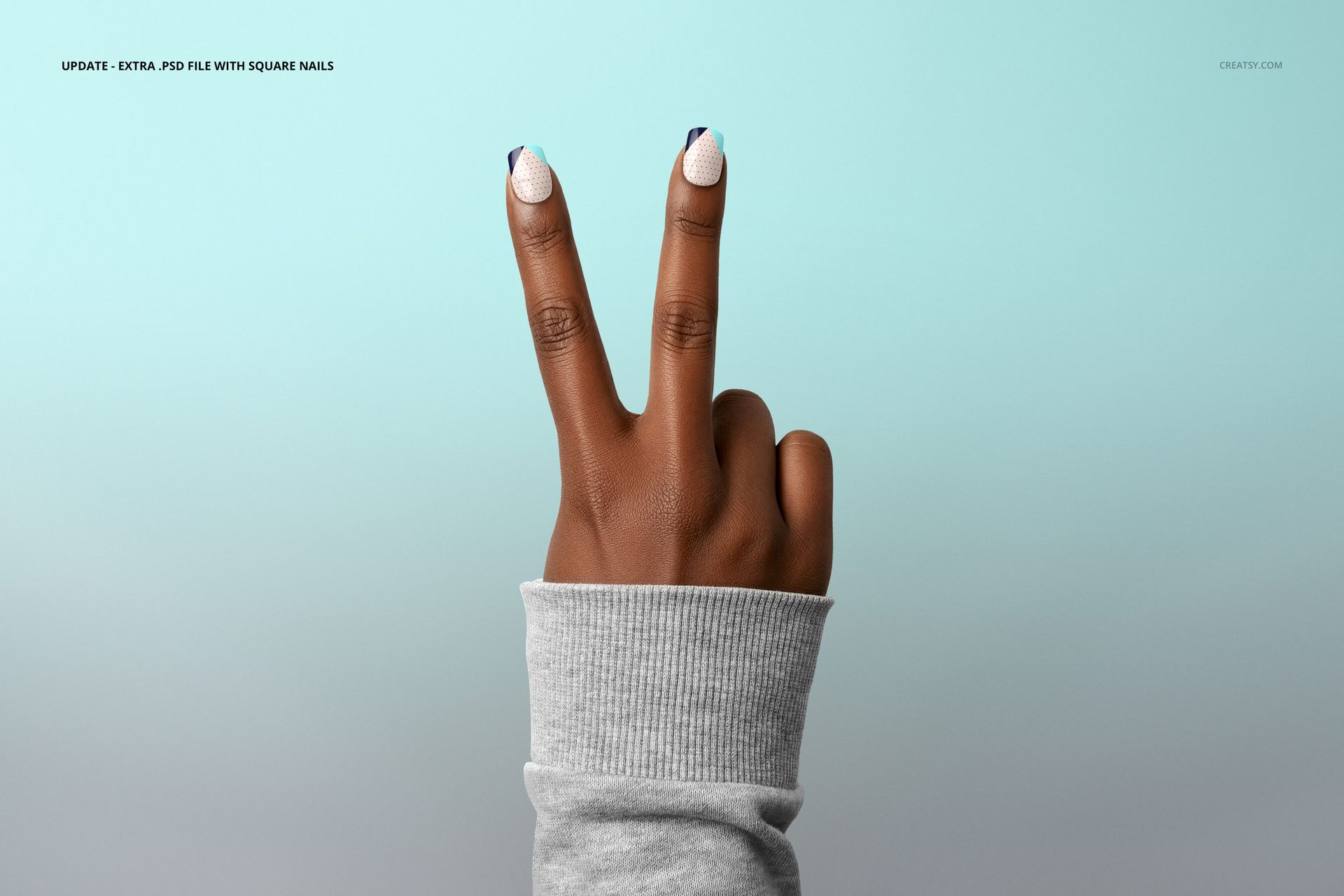 PSD mockup of a hand in a peace gesture, nails painted in white and blue, wearing a gray sleeve, on blue background.