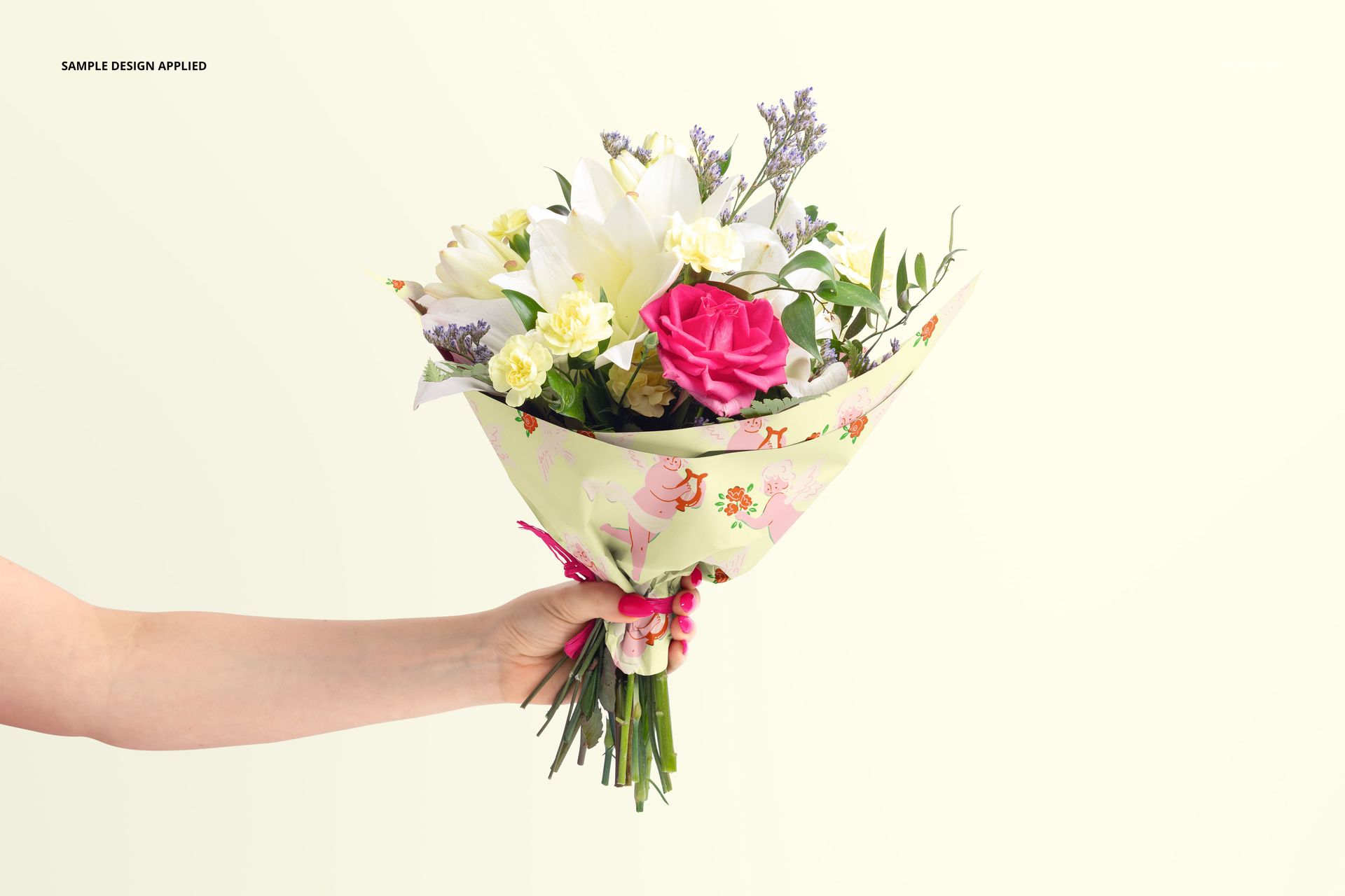PSD mockup of flower packaging featuring colorful floral patterns, held in one hand with visible stems and blooms.