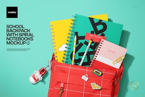 PSD mockup featuring a school backpack with vibrant spiral-bound notebooks and stationery items against a blue backdrop.