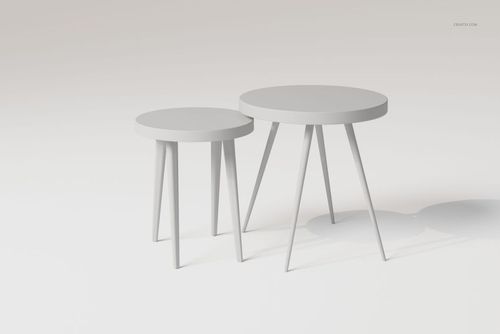 Two round nesting tables with minimalist design, light gray color, and angled legs, shown on a plain background.