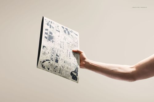 PSD mockup of a kraft mailer with black line art illustrations, held in one hand, displayed on a neutral background.
