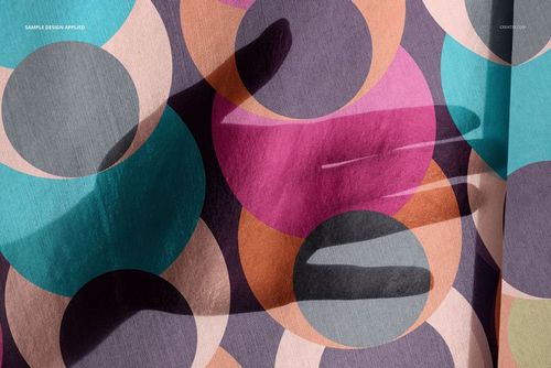 Close-up of a habotai silk scarf mockup with vibrant circular patterns in pink, teal, orange, and gray tones.