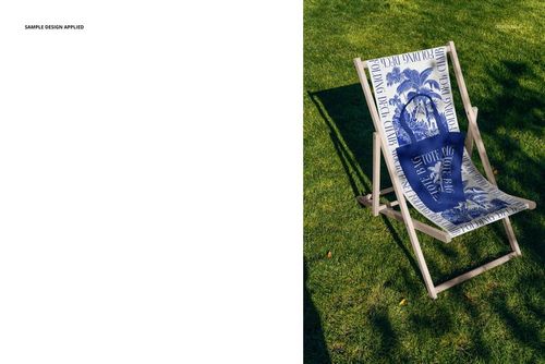 Single folding deck chair mockup featuring a tropical blue and white design, placed outdoors on a lawn.