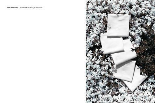 Stacked fabric samples in neutral tones arranged on a bed of white blooms, viewed from above in a mockup scene.