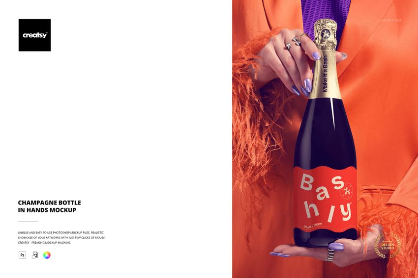 PSD mockup showing a champagne bottle gripped by manicured hands, featuring a bold orange label and gold foil neck.