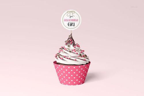 PSD mockup of a decorated cupcake with heart-patterned wrap and topper, displayed against a pastel pink backdrop.