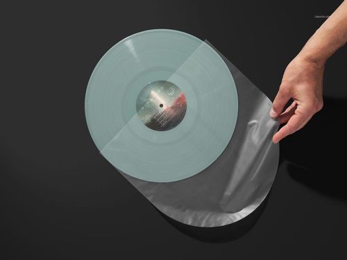 PSD mockup of a colored vinyl record partially inside a clear sleeve, displayed on a black background, top perspective.