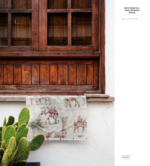PSD mockup of a fabric sample with illustrated animals, attached to a white wall beside a cactus and wooden window.