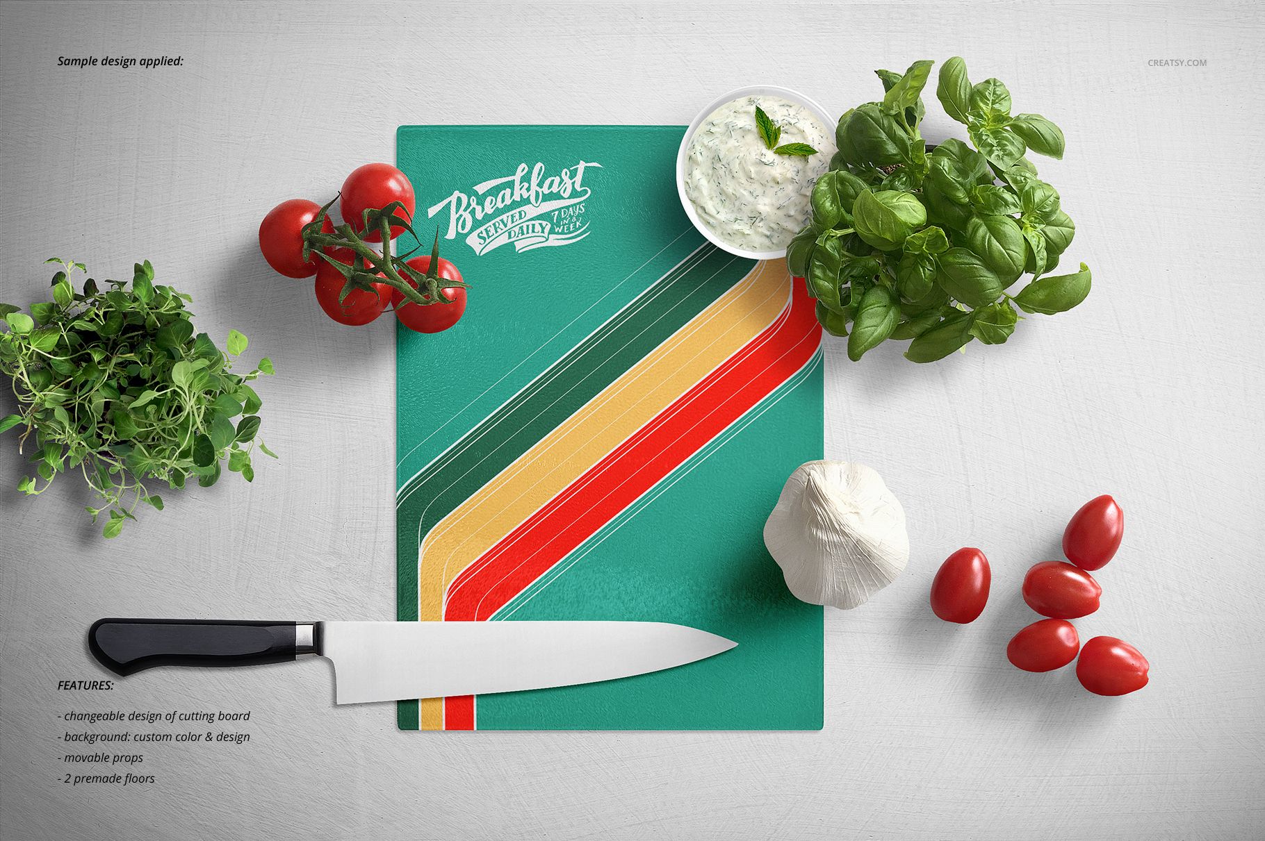Top view of a mockup set featuring a rectangular glass cutting board with a striped design and kitchen props including tomatoes and herbs.