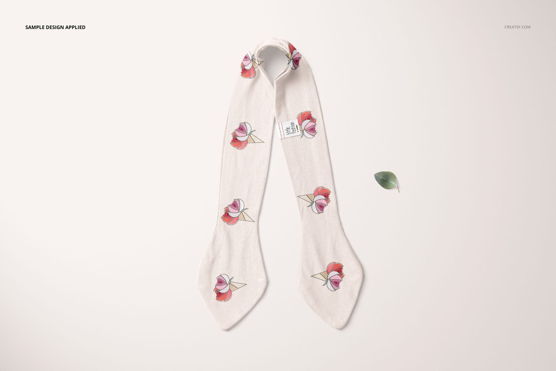 Front view of a swaddle set mockup with a soft cream fabric featuring pink floral patterns and a small tag.