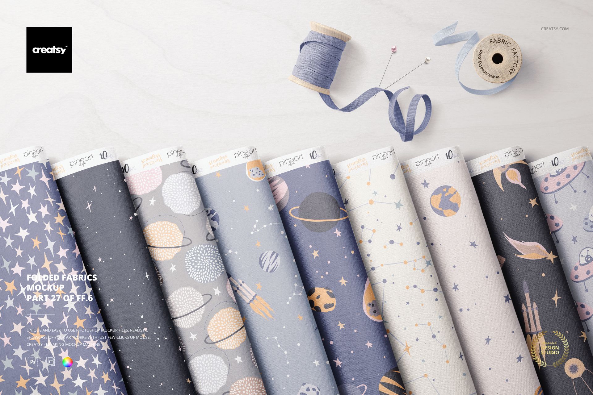 Folded fabrics arranged in a row on a light surface, displaying pastel and space-themed patterns from a top view.