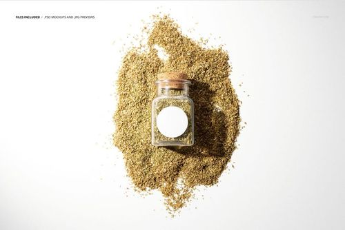 Oregano jar PSD mockup showing a transparent container with a white label, surrounded by dried oregano on a light backdrop.
