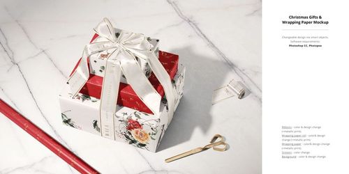 Christmas decor mockup featuring wrapped presents with floral patterns, ribbon bow, gold scissors, and festive props on a table.