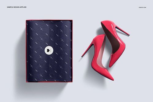Shoe box mockup featuring a navy tissue paper with subtle pattern and two pink stiletto heels beside the box.