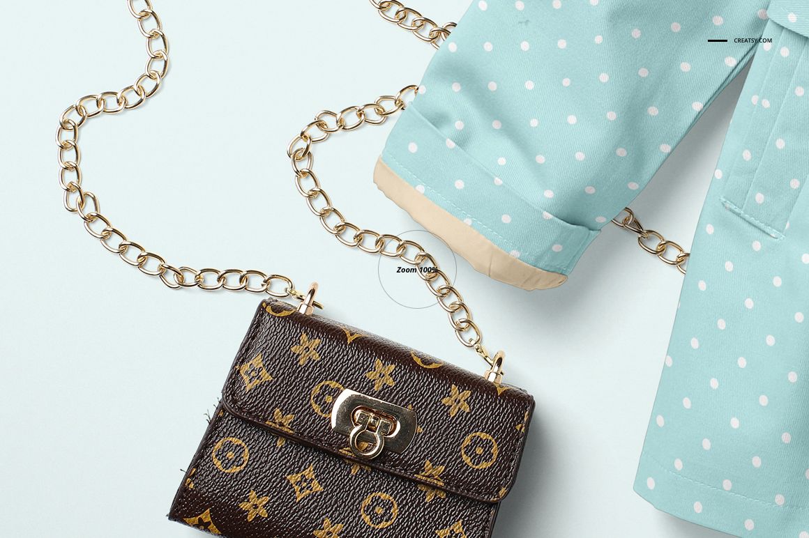 Light blue baby coat with white polka dots and beige cuffs, shown with gold chain and small patterned purse.