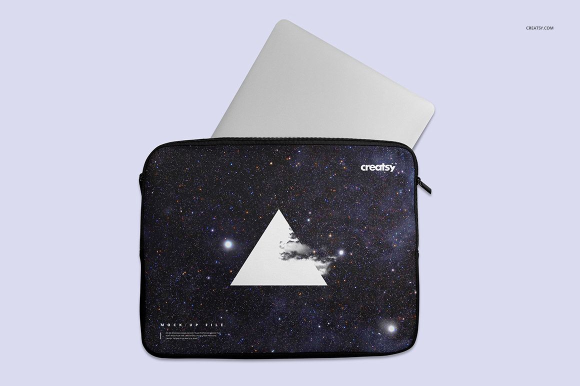 PSD mockup of a laptop sleeve displaying a space-themed design and triangle motif, silver laptop visible in the background.