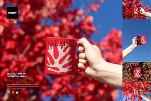PSD mockup of a red mug with white graphic pattern, shown outdoors near vivid red-leaved trees and blue sky.