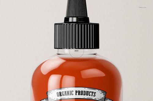 Front view of a clear sauce bottle mockup with a black screw cap, filled with red liquid and a white label.