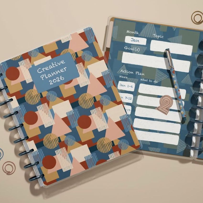 Two spiral-bound planner mockups seen from above, featuring abstract geometric patterns and a pen resting on an open page.