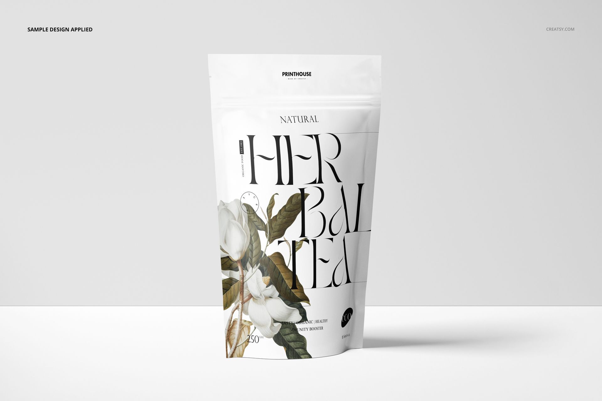 Front-facing stand up zip lock bag mockup featuring floral artwork and bold lettering, set against a minimal backdrop.