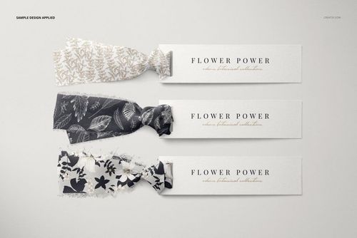 PSD mockup featuring three decorative silk ribbons with paper tags, each ribbon in a unique botanical print, top perspective.