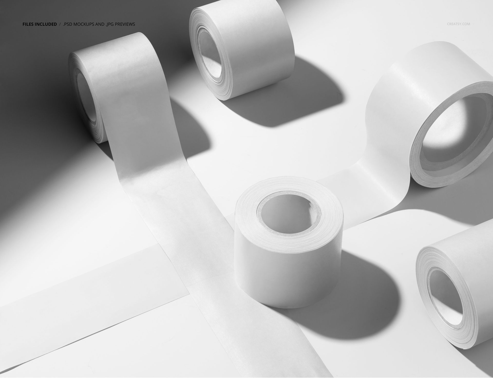 PSD mockup showing white packaging tapes in various positions, including unrolled strips and stacked rolls on a bright surface.
