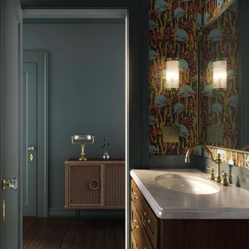 Art deco bathroom mockup with a marble countertop, brass fixtures, and bold patterned wallpaper beside a muted blue hallway.