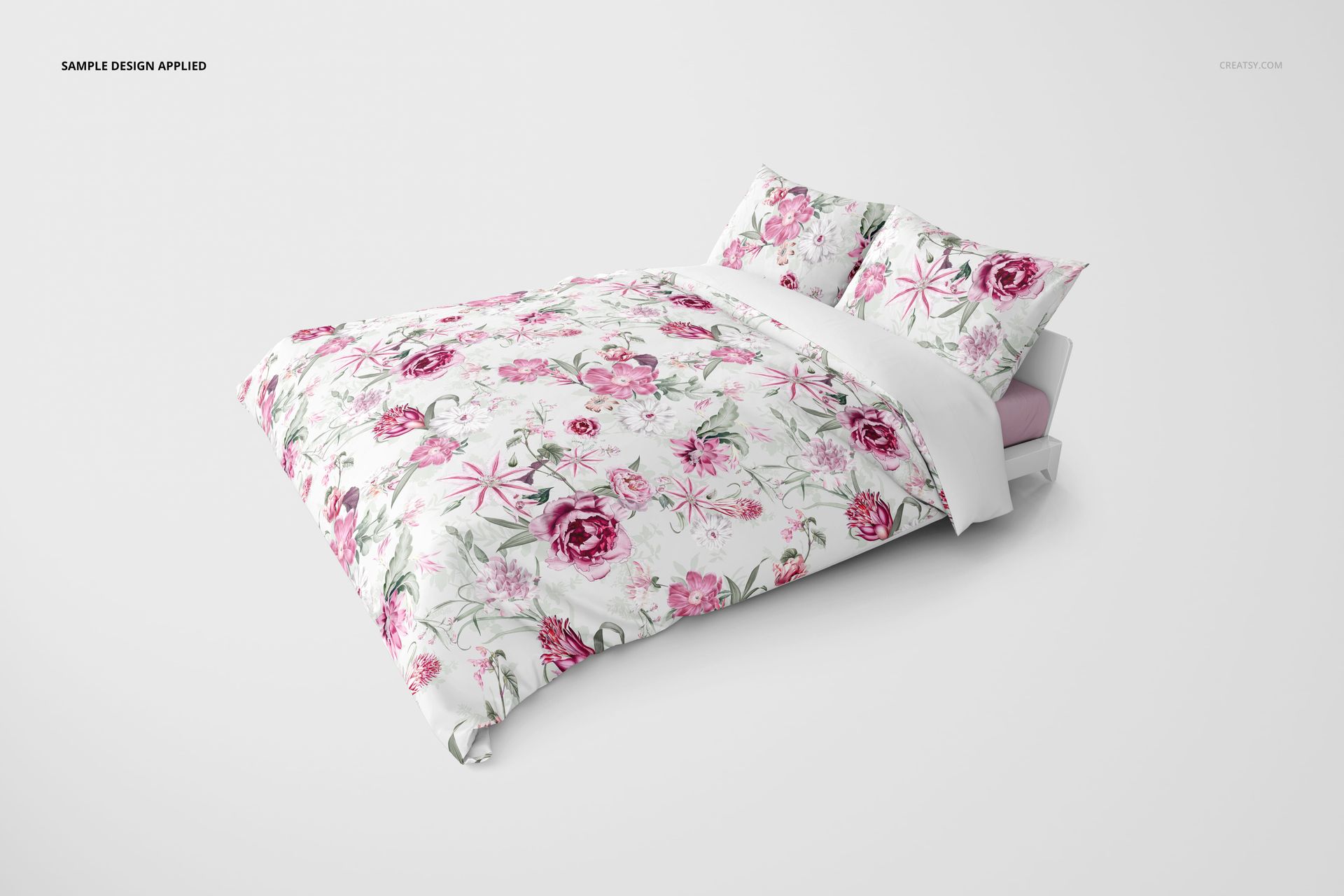 Front view of a bedding set mockup featuring a duvet and two pillows with a pink floral pattern on white background.