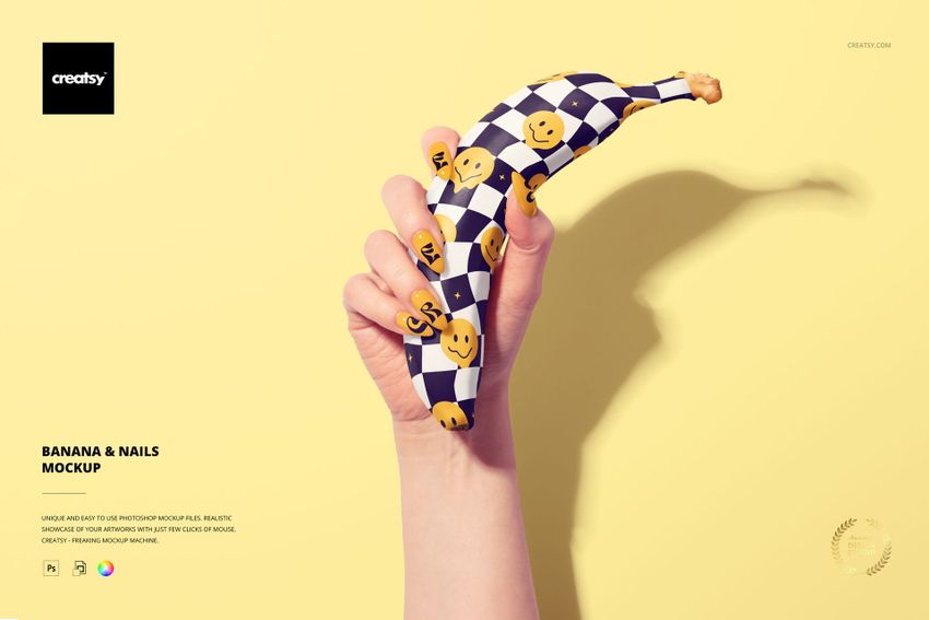 PSD mockup featuring a hand holding a patterned banana with smiley faces, shown on a pale yellow background.