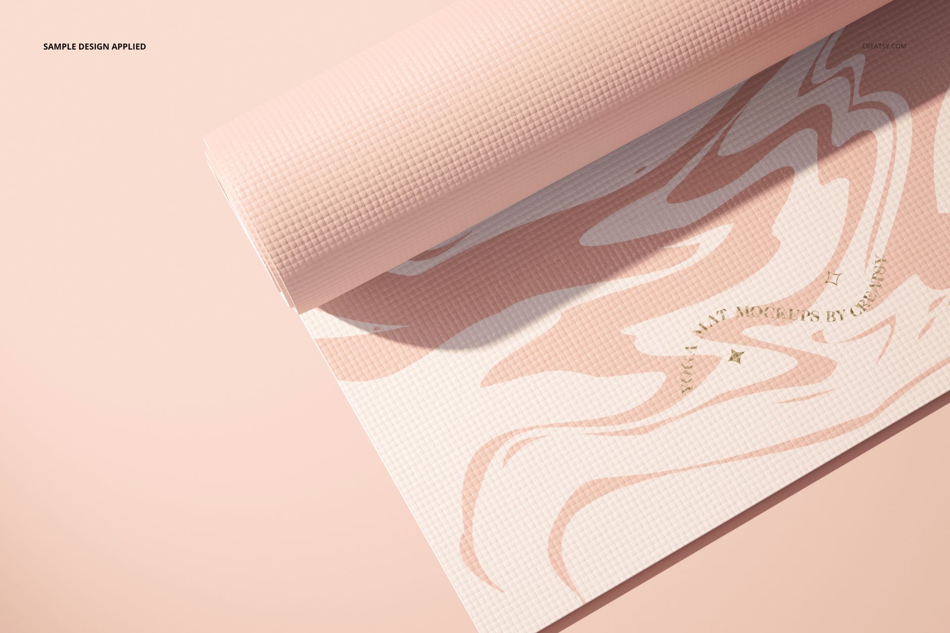 Yoga mat mockup featuring a soft pink marbled design, partially unrolled on a pastel pink background.