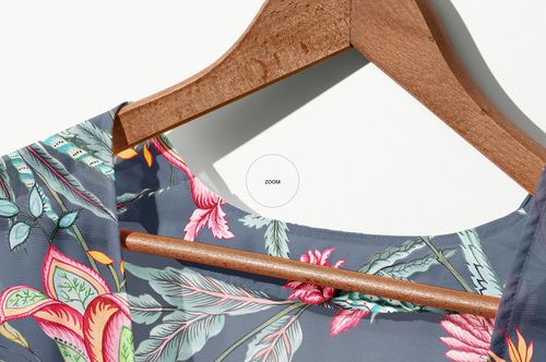 Close-up of a chiffon kimono mockup featuring vibrant pink and green flowers and leaves, shown on a hanger.