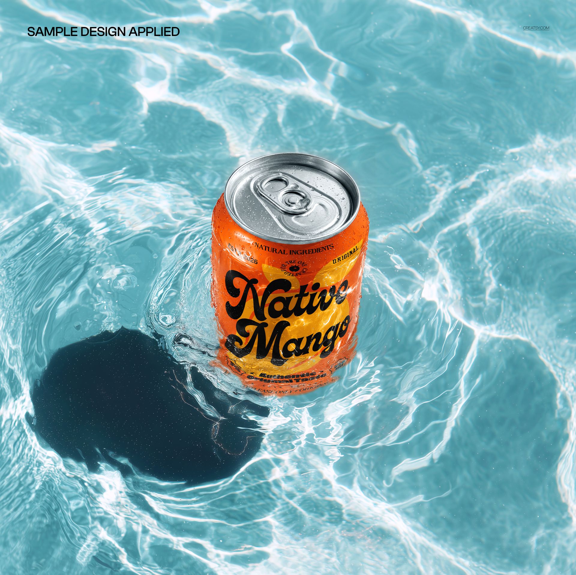 High angle view of a soda can with orange and black design floating in clear blue water, drinkware mockup scene.