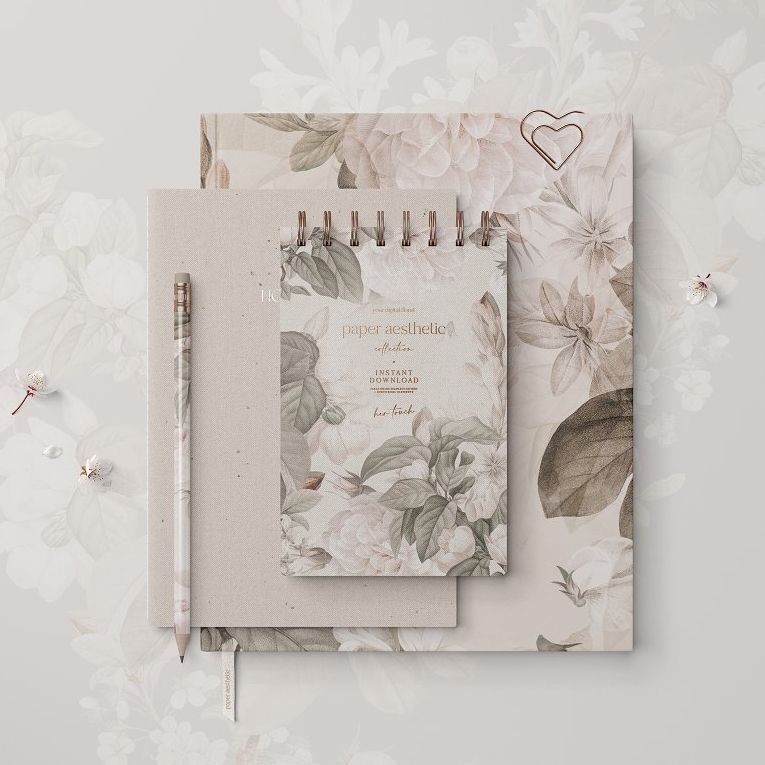 Stationery set mockup featuring a spiral notebook, hardcover book, and pencil with soft floral patterns in beige and white tones.