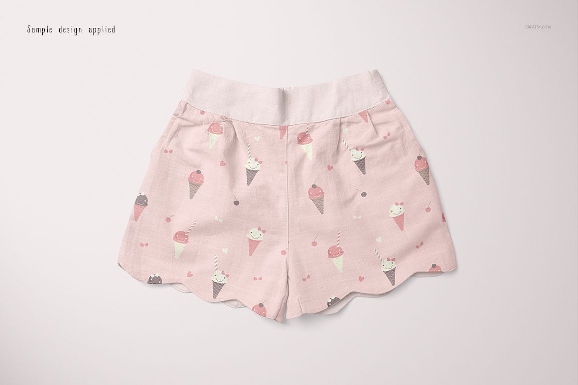 Front view of baby shorts mockup with light pink fabric and ice cream cone pattern, displayed on a plain background.