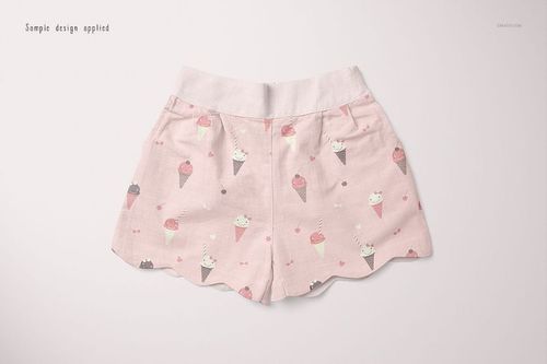 Front view of baby shorts mockup with light pink fabric and ice cream cone pattern, displayed on a plain background.