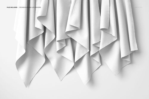 PSD mockup showing hanging fabrics with soft folds, viewed from the front on a simple white surface.