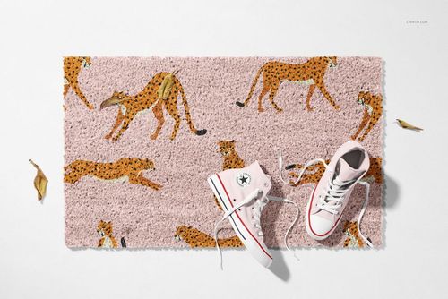 Natural coir door mat mockup with animal print design, shown from above with casual footwear and autumn leaves nearby.