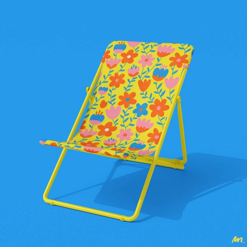 Folding beach chair mockup with a bright yellow frame and a floral pattern in pink, orange, and blue on a solid blue background.