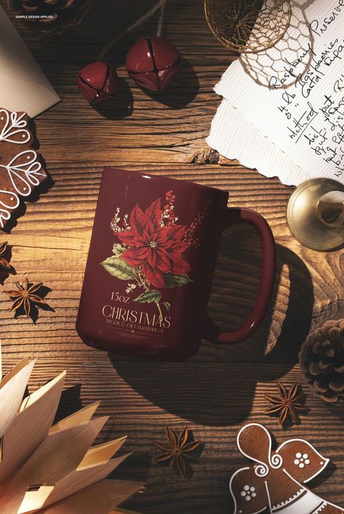 Rustic Christmas mug mockup featuring a deep red 15 oz mug with poinsettia artwork on a wooden table surrounded by festive props.