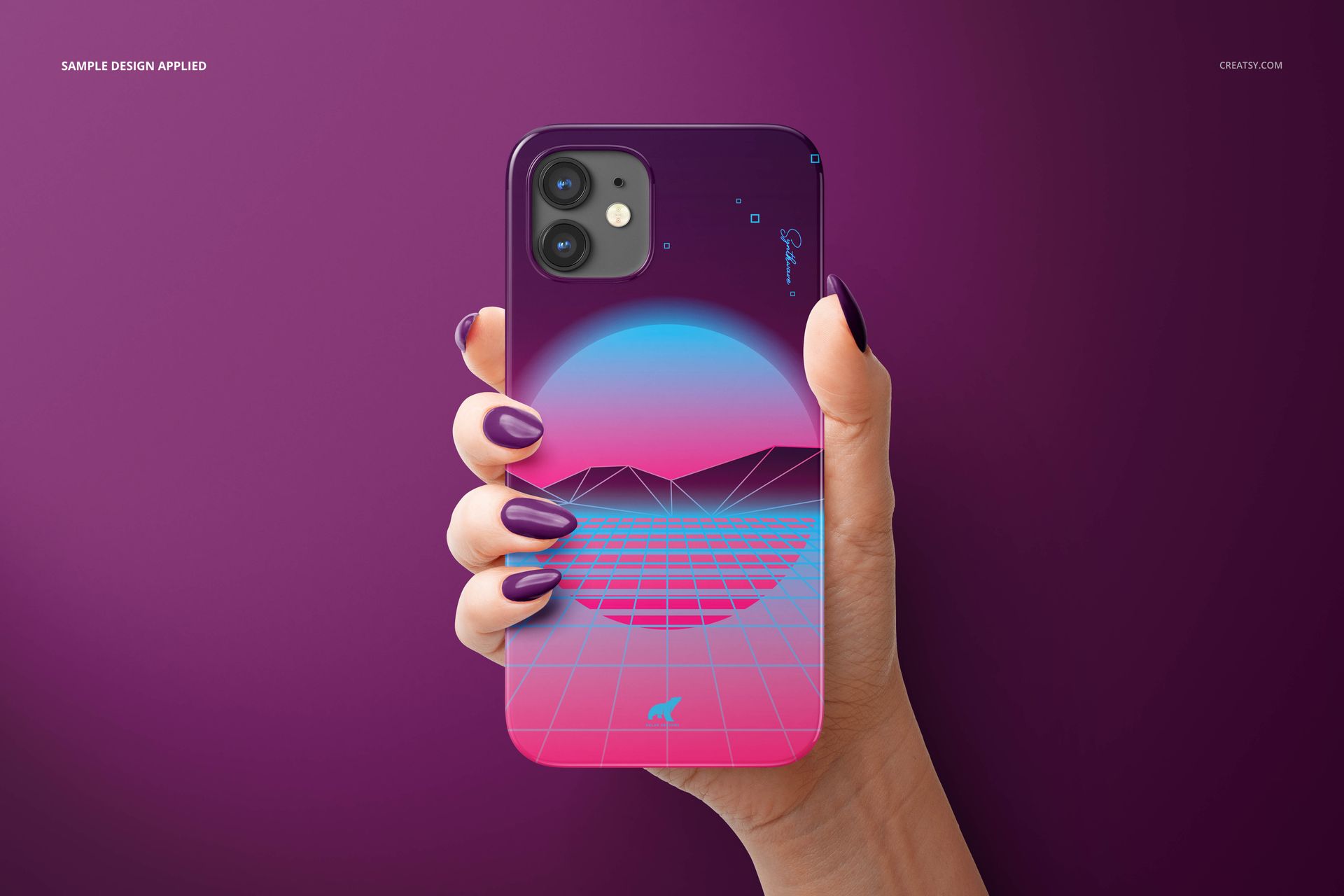 Front view of an iPhone 12 glossy snap case mockup, displaying a vibrant geometric landscape design, set against a purple backdrop.