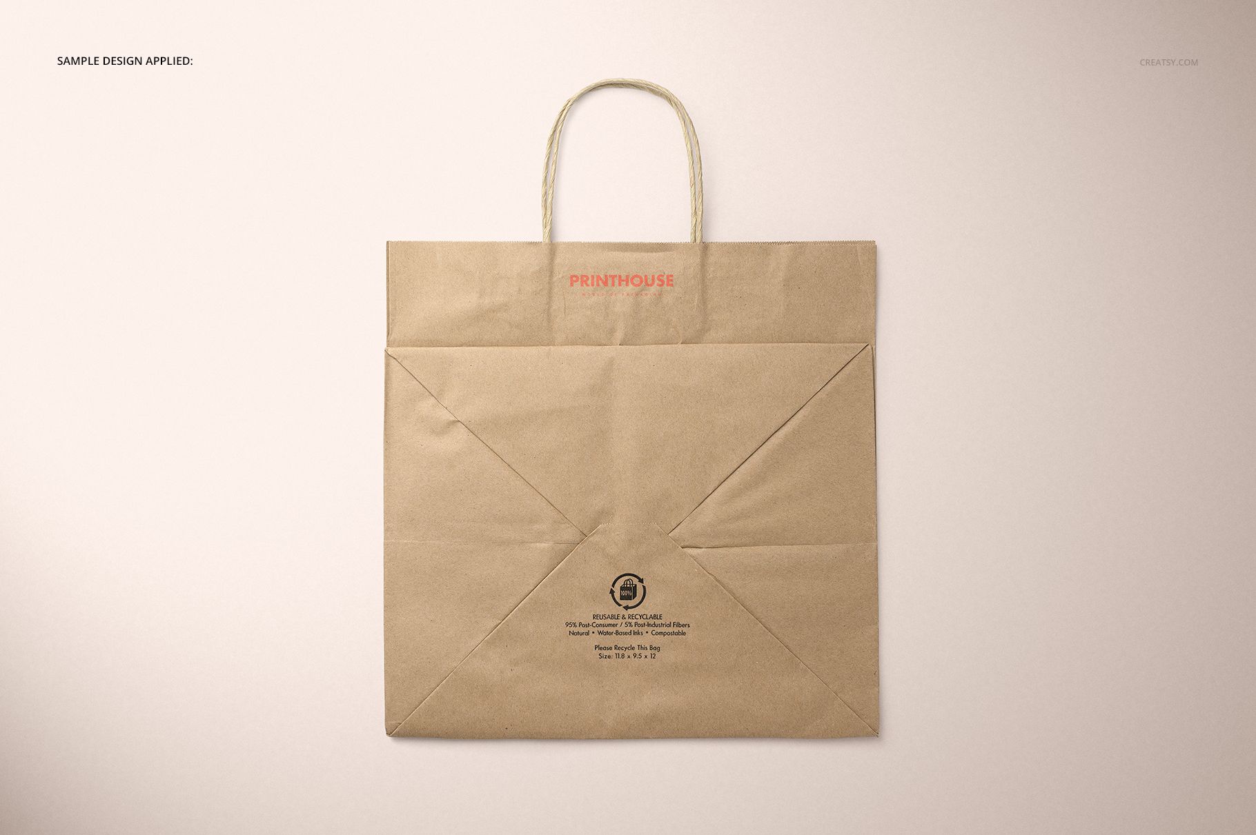 Front view of a natural kraft shopping bag mockup with twisted paper handles, displayed on a light surface.