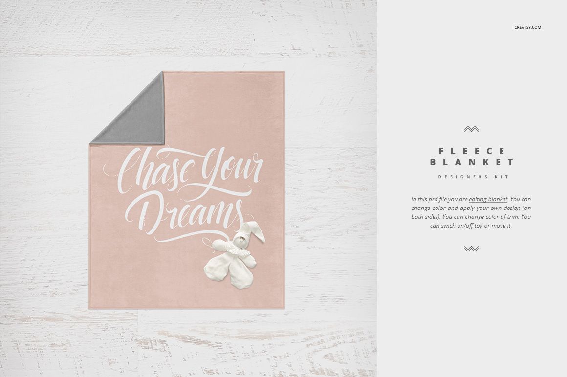 Square crib blanket mockup in soft pink with white script text, gray corner, and plush toy on wooden surface.