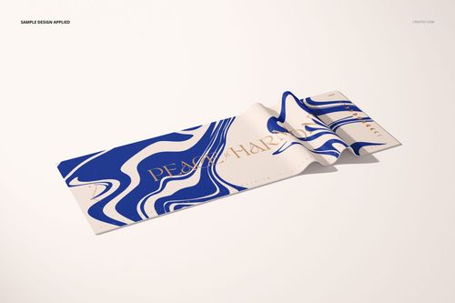 Yoga mat mockup featuring bold blue and white swirls and gold text, displayed on a neutral surface in perspective view.