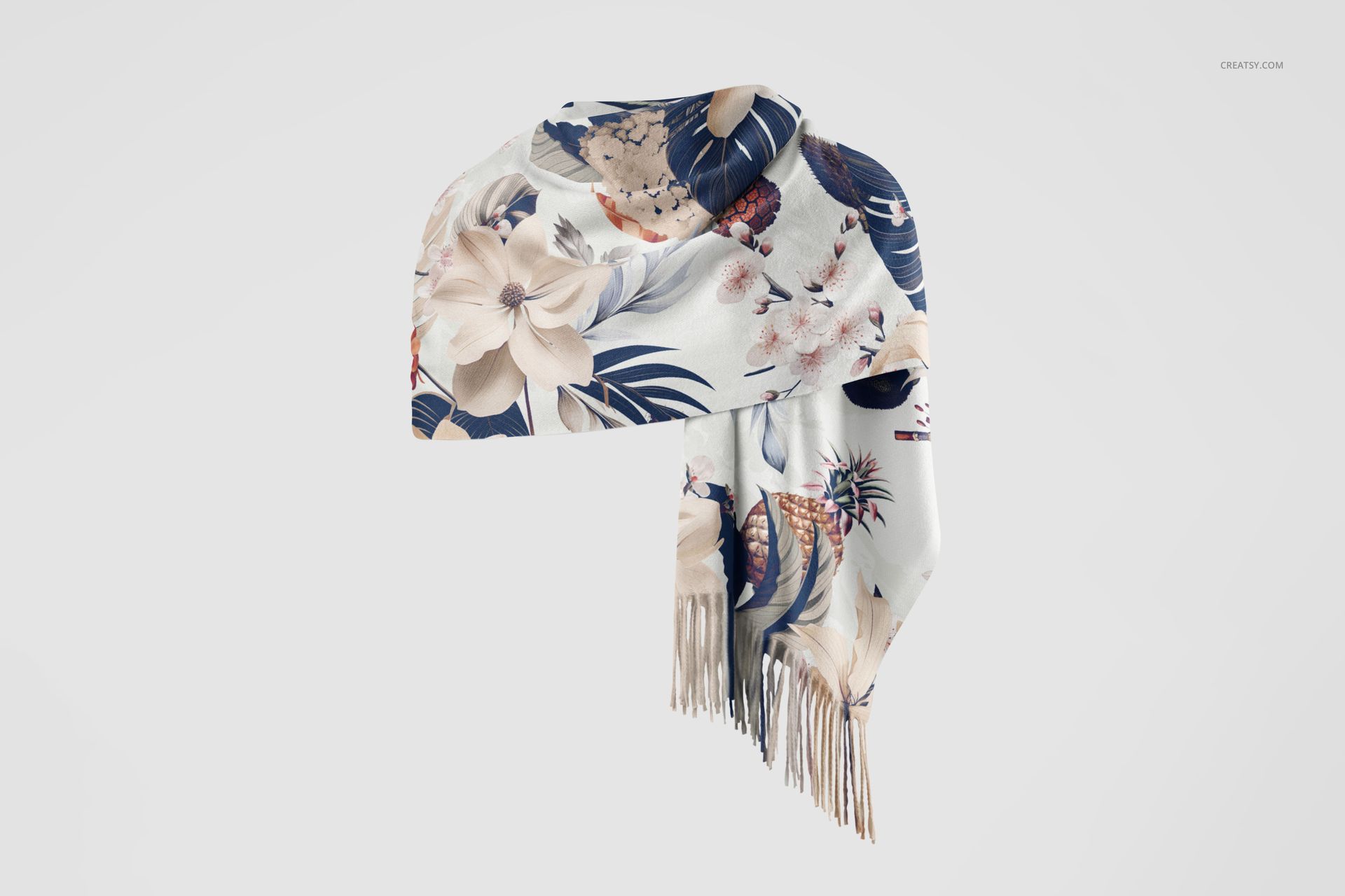 Front view of a cashmere scarf mockup with a floral pattern in pastel and navy tones, draped and showing fringed edges.