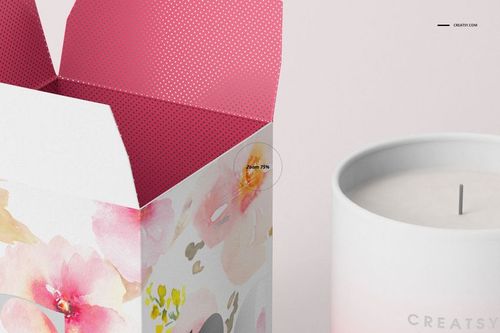 Matte glass candle mockup beside a watercolor floral box with open lid, shown from a close-up front angle.